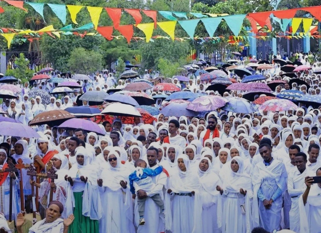 Mass Assembly of Devotees Praying under Demera Pennants